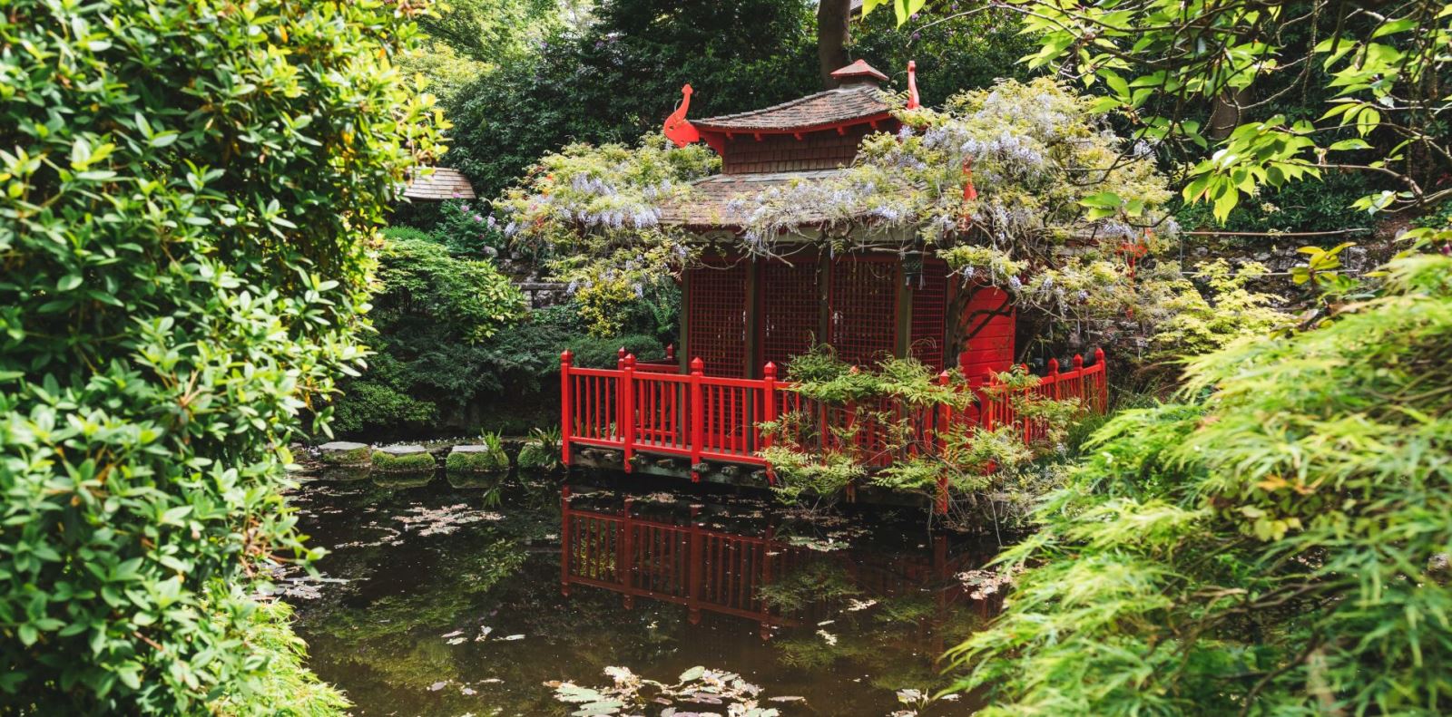 red japenese house located amongst compton acres garden in Poole 